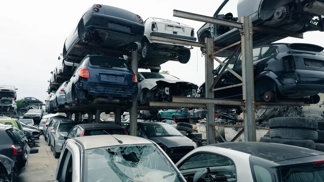 Stacked scrap cars awaiting vehicle recovery and component salvage